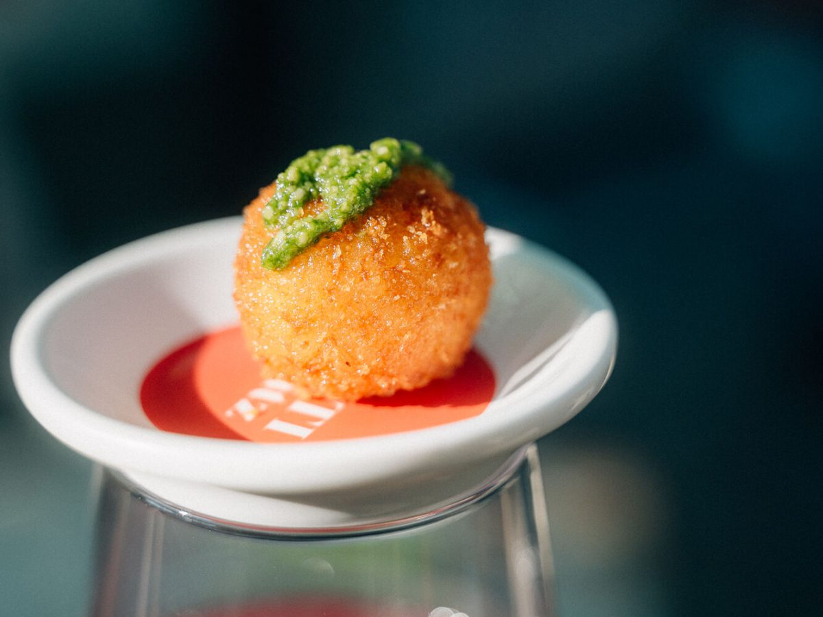Frittierte Arancini mit Kräutercreme, angerichtet auf einem Spritz-Glas